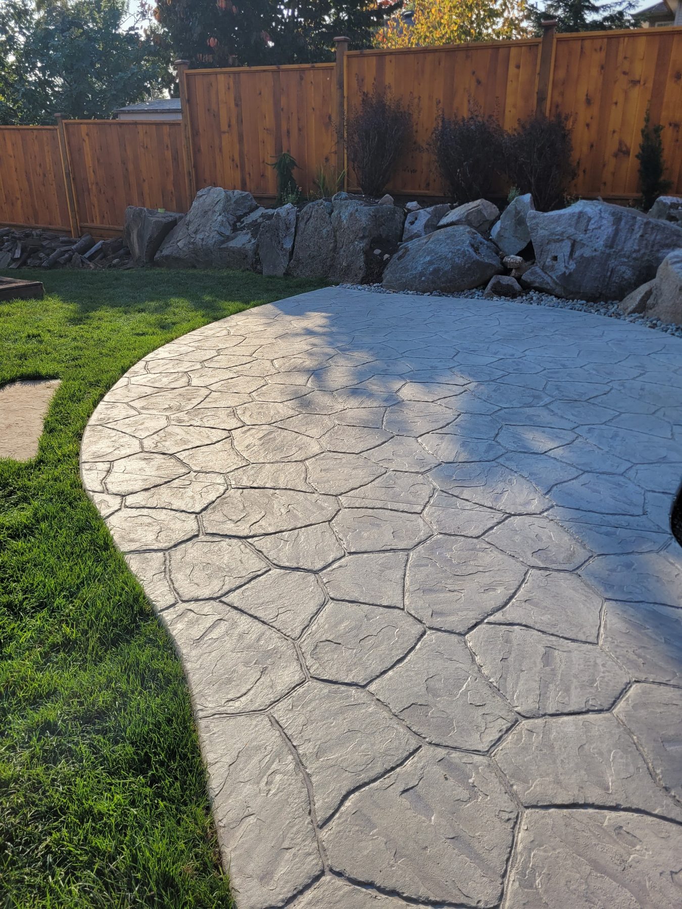Stamped concrete patio with stone pattern finish in a Lower Mainland backyard